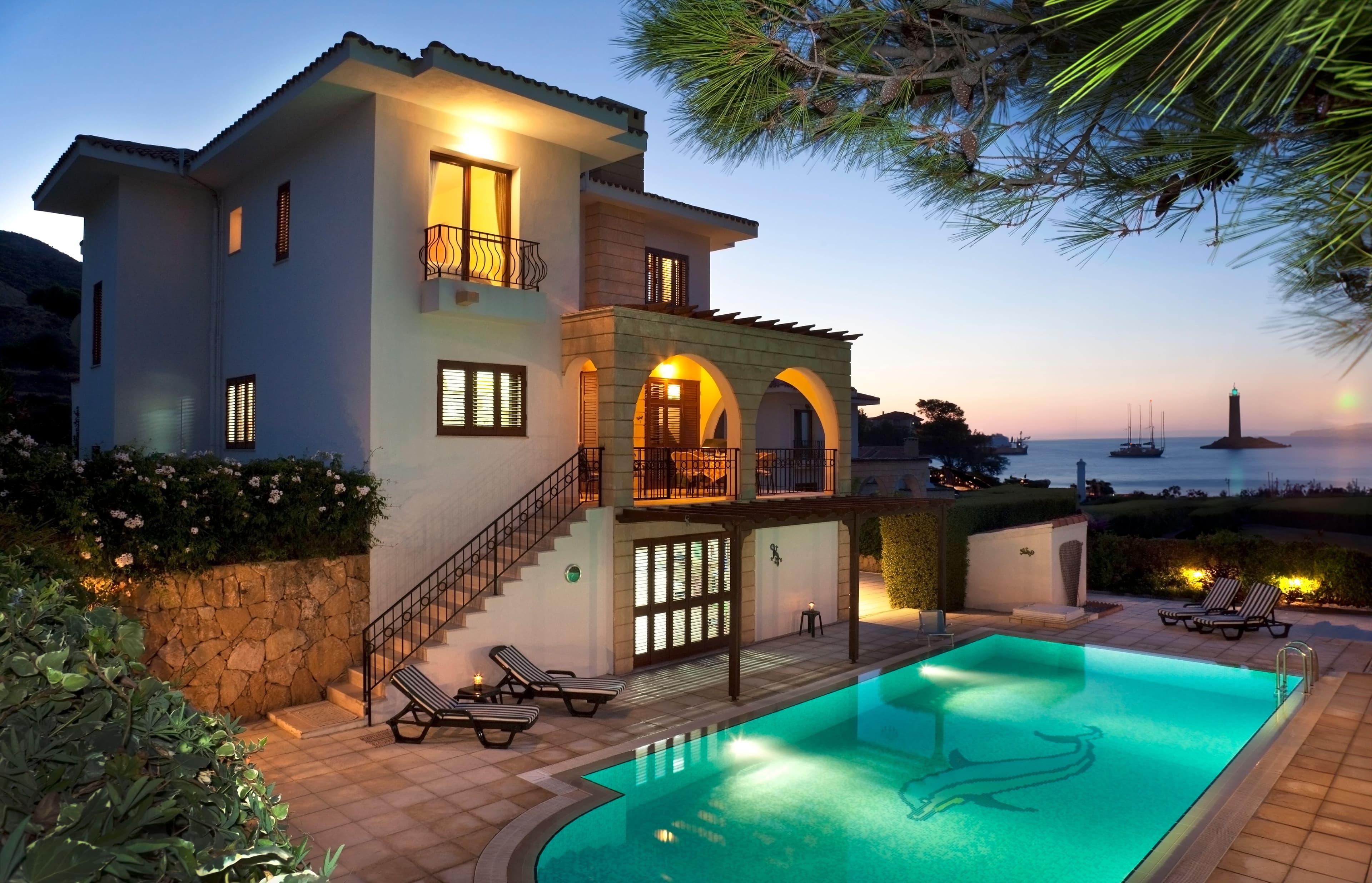 Villa with pool near the ocean at sunset