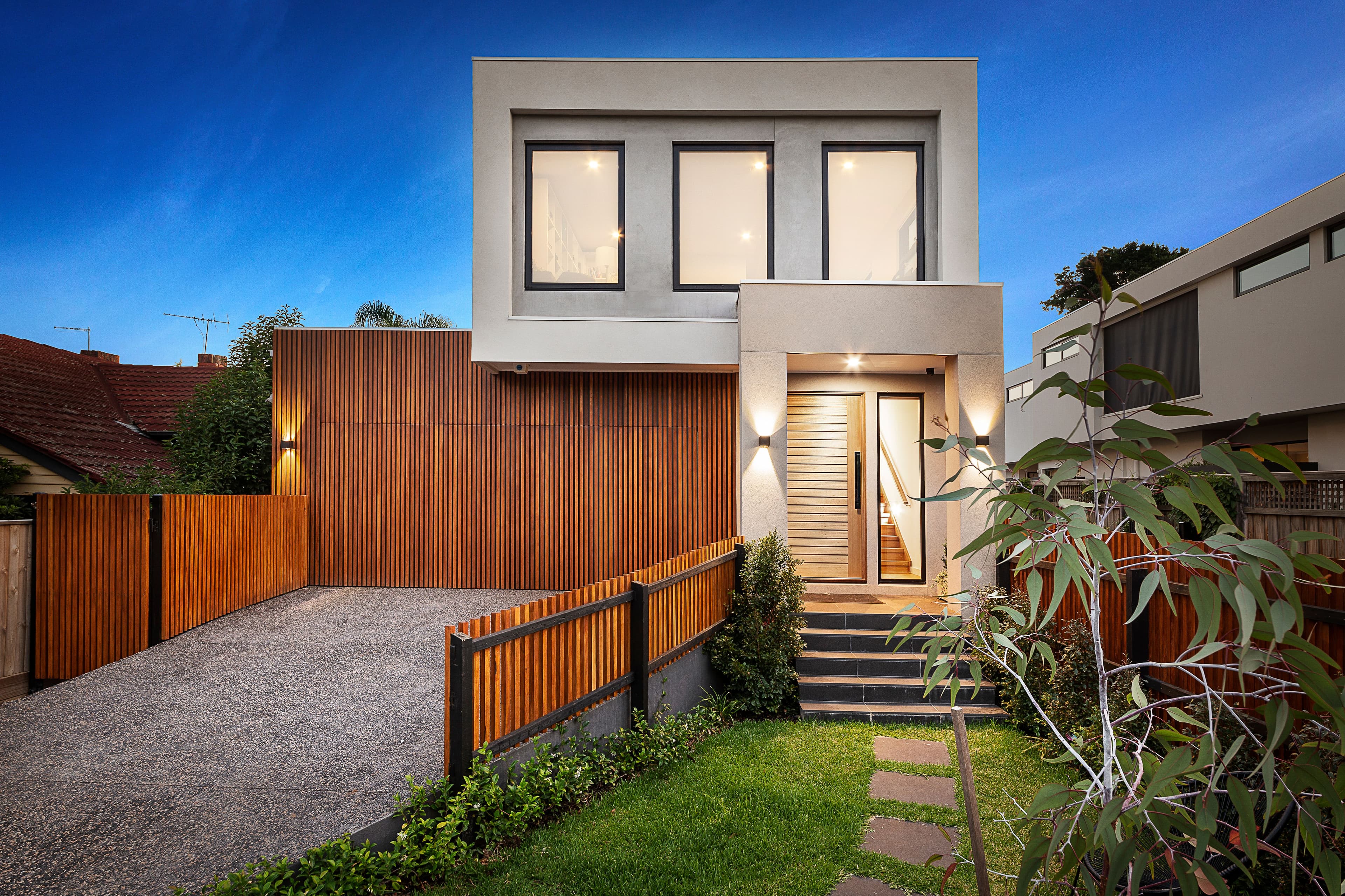 Contemporary House With Wooden Facade and Green Lawn