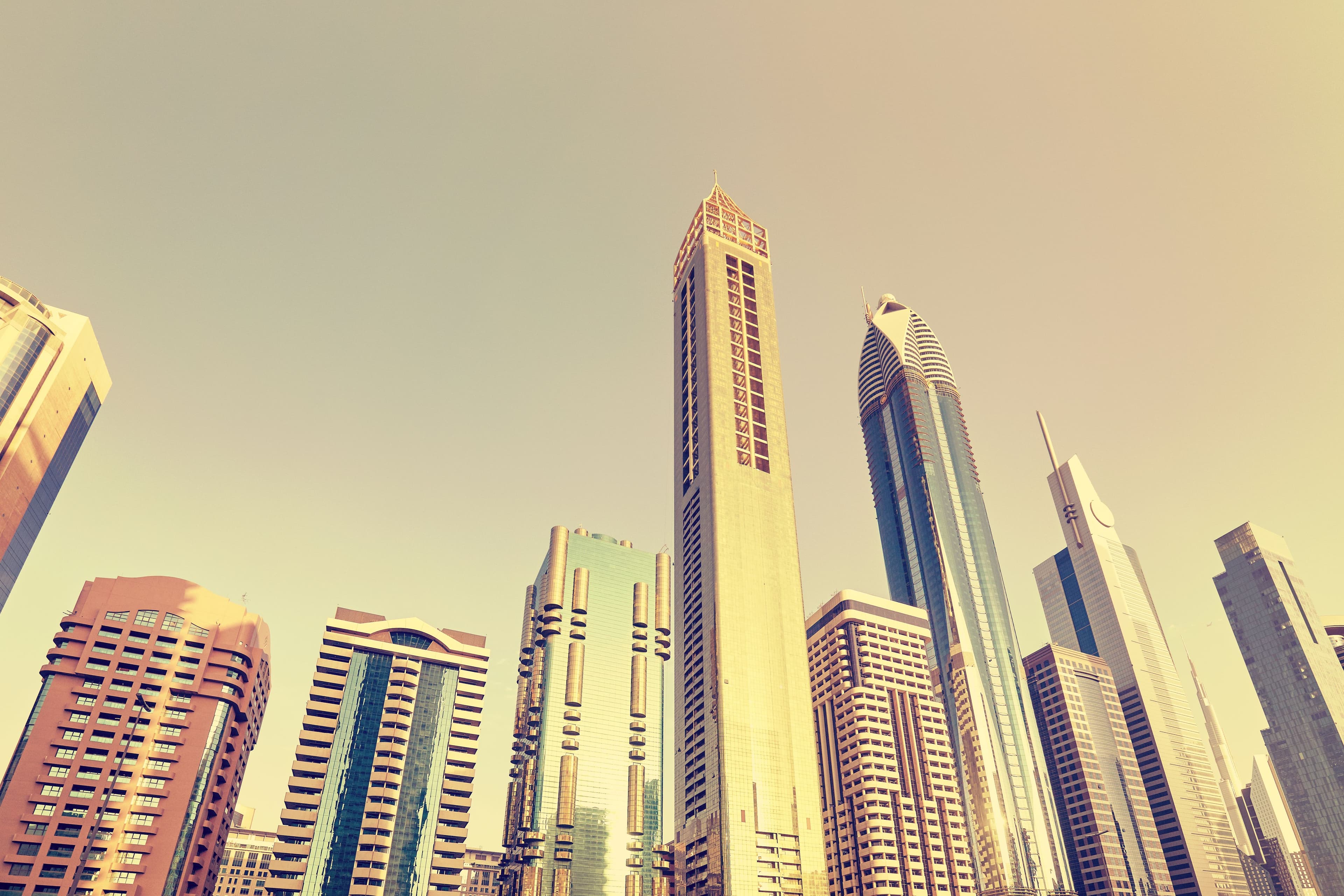 Looking up at Dubai skyscrapers skyline.