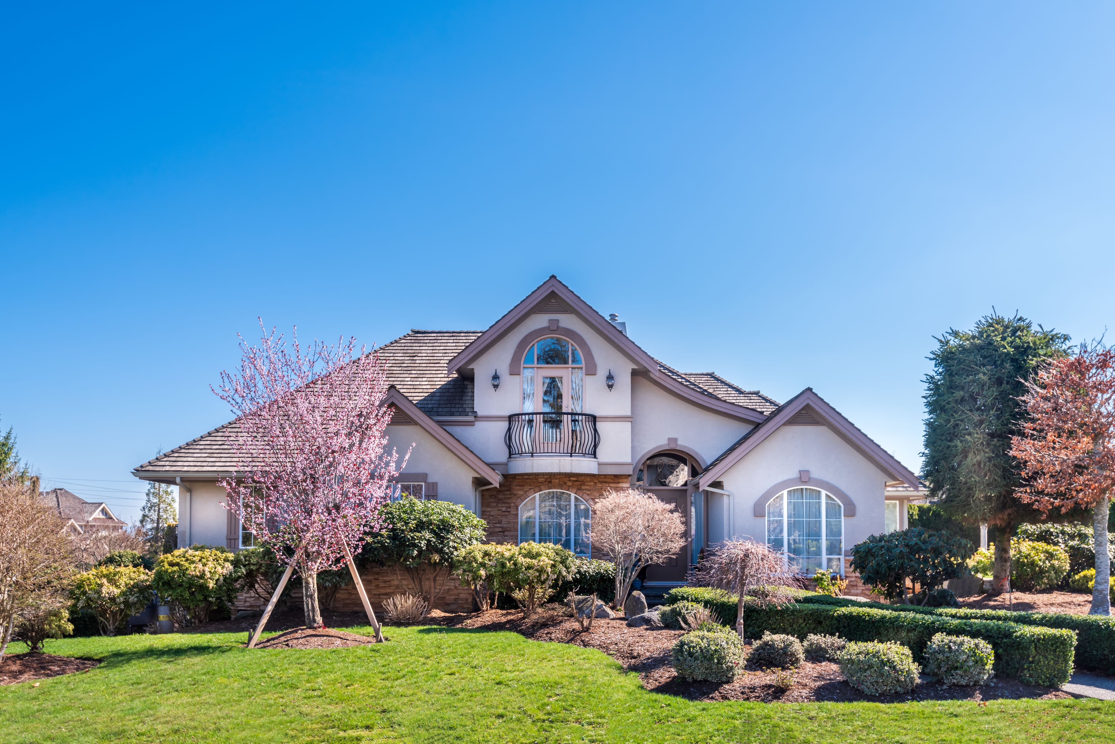 Beautiful Exterior Of Newly Built Luxury Home. Yard With Green Grass And Nice Landscape.